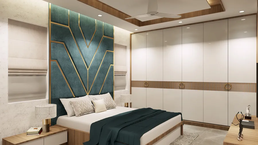Dining corner with soft-green sofas, patterned kitchen screen, and a sculptural gold wall piece